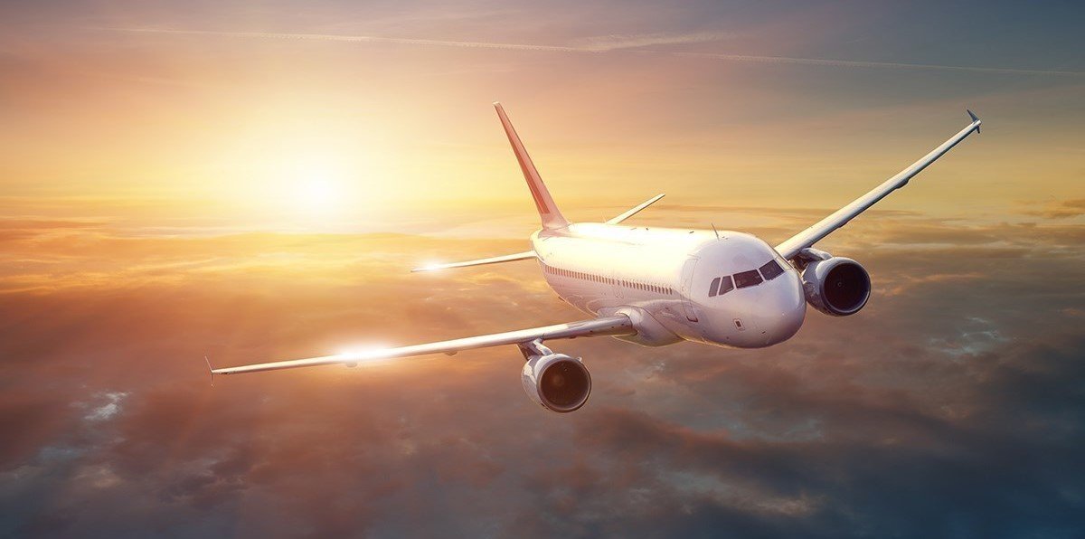 Inside an airplane, passengers seated on seats, ready for takeoff.